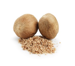 Photo of Whole nutmegs and powder isolated on white