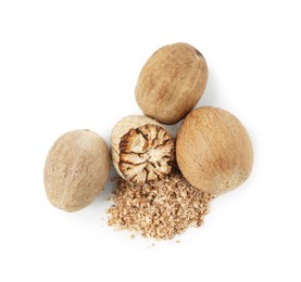 Photo of Whole, cut nutmegs and powder isolated on white, top view