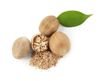 Photo of Whole, cut nutmegs, powder and leaf isolated on white, top view