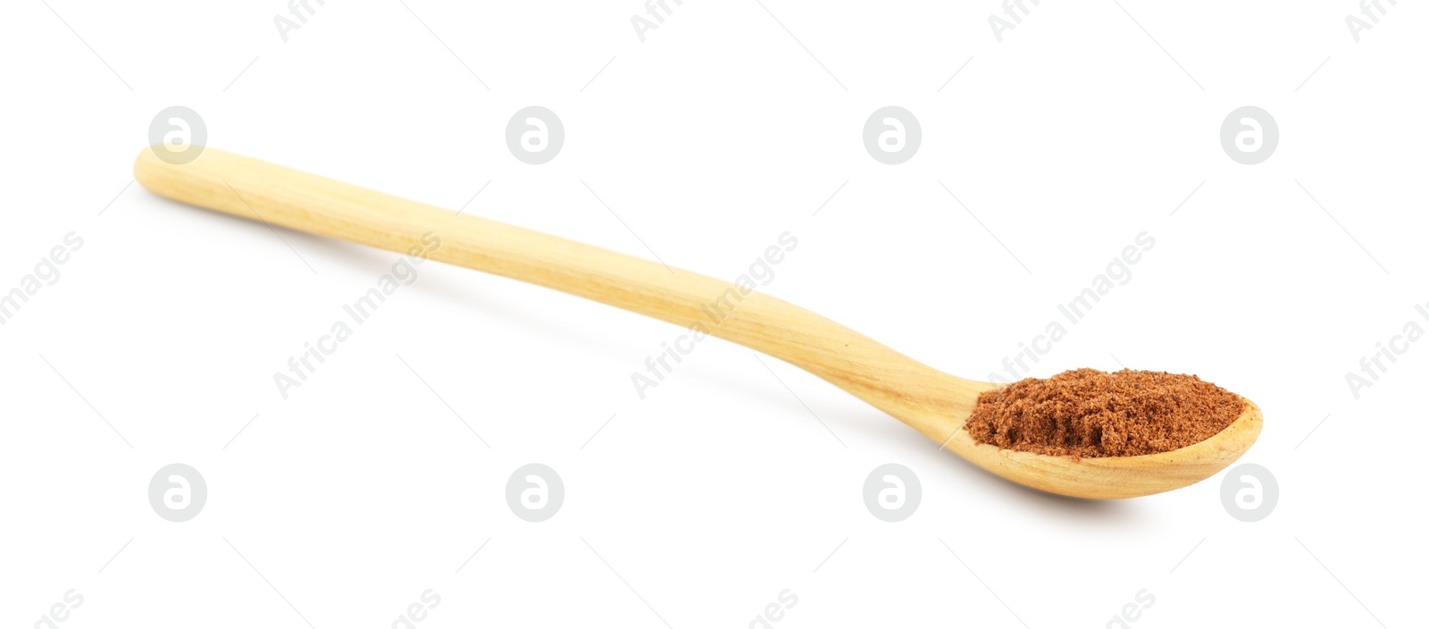 Nutmeg powder in spoon isolated on white Photo of Nutmeg powder in spoon isolated on white