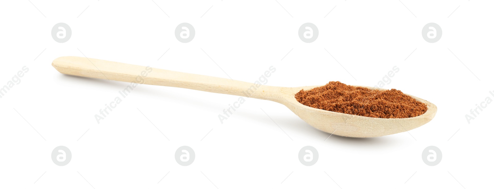 Photo of Nutmeg powder in spoon isolated on white