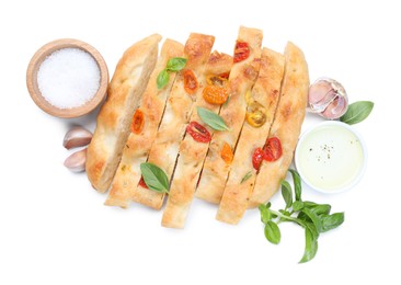 Photo of Cut delicious focaccia with tomatoes, spices and oil isolated on white, top view