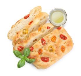 Photo of Cut delicious focaccia with tomatoes, basil and oil isolated on white, top view