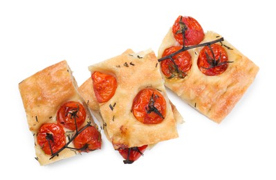 Photo of Pieces of delicious focaccia with tomatoes and spices isolated on white, top view