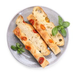 Photo of Pieces of delicious focaccia with tomatoes and basil isolated on white, top view