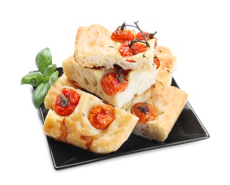 Photo of Pieces of delicious focaccia with tomatoes and basil isolated on white