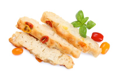 Photo of Pieces of delicious focaccia with tomatoes and basil isolated on white, top view