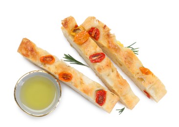 Photo of Pieces of delicious focaccia with tomatoes, rosemary and oil isolated on white, top view