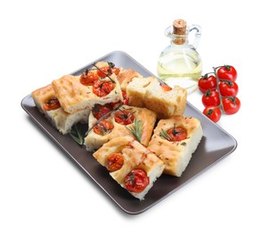 Photo of Pieces of delicious focaccia with tomatoes, spices and oil isolated on white