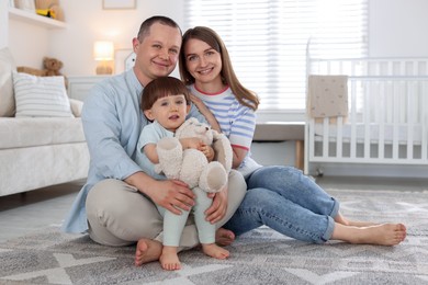 Photo of Cute little boy and his parents at home. Lovely family