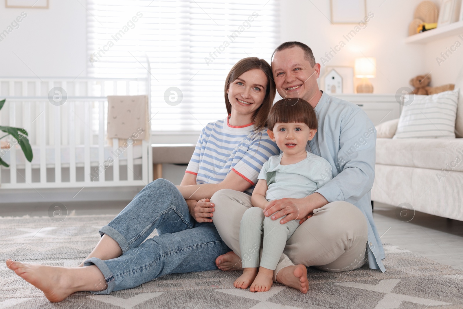 Cute little boy and his parents at home. Lovely family Photo of Cute little boy and his parents at home. Lovely family