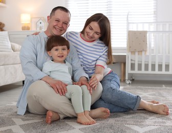 Photo of Cute little boy and his parents at home. Lovely family