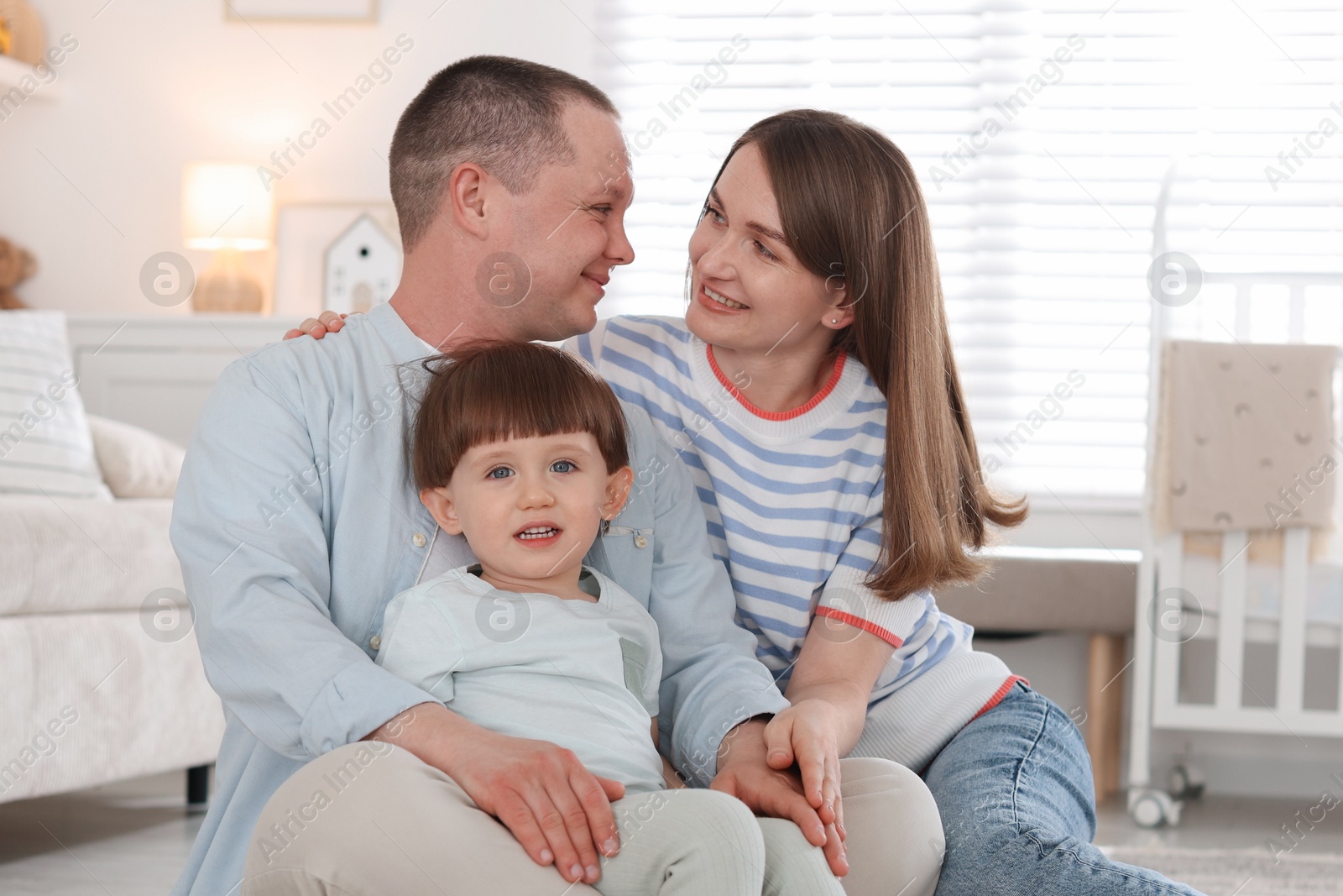 Cute little boy and his parents at home. Lovely family Photo of Cute little boy and his parents at home. Lovely family