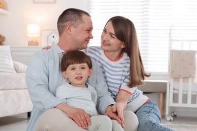 Photo of Cute little boy and his parents at home. Lovely family