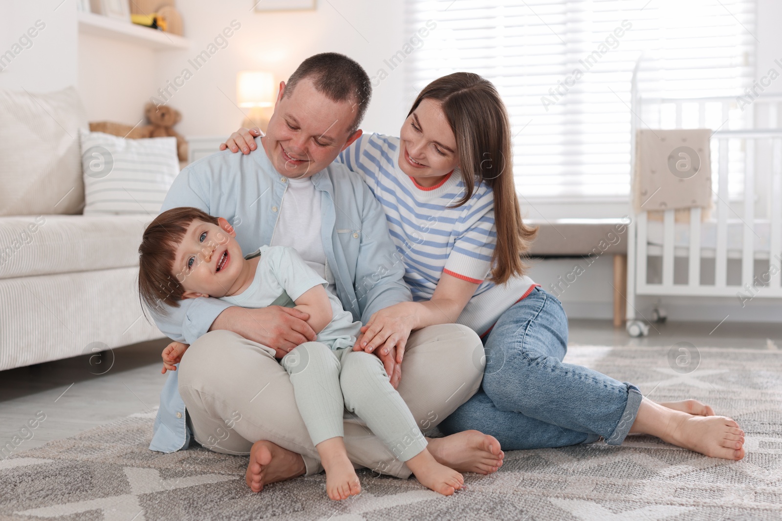 Cute little boy and his parents at home. Lovely family Photo of Cute little boy and his parents at home. Lovely family