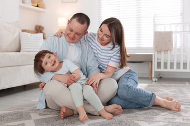 Photo of Cute little boy and his parents at home. Lovely family