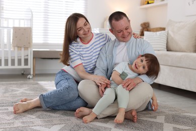 Photo of Cute little boy and his parents at home. Lovely family