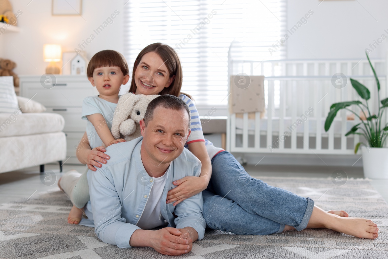 Cute little boy and his parents at home. Lovely family Photo of Cute little boy and his parents at home. Lovely family
