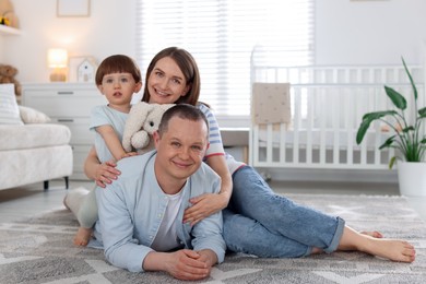 Photo of Cute little boy and his parents at home. Lovely family
