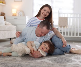 Photo of Cute little boy and his parents at home. Lovely family