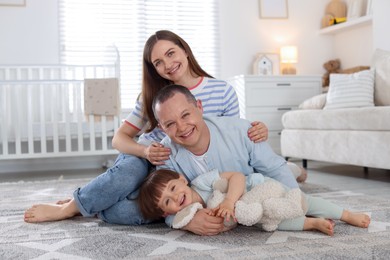 Photo of Cute little boy and his parents at home. Lovely family