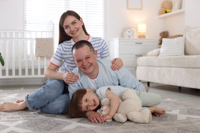 Photo of Cute little boy and his parents at home. Lovely family