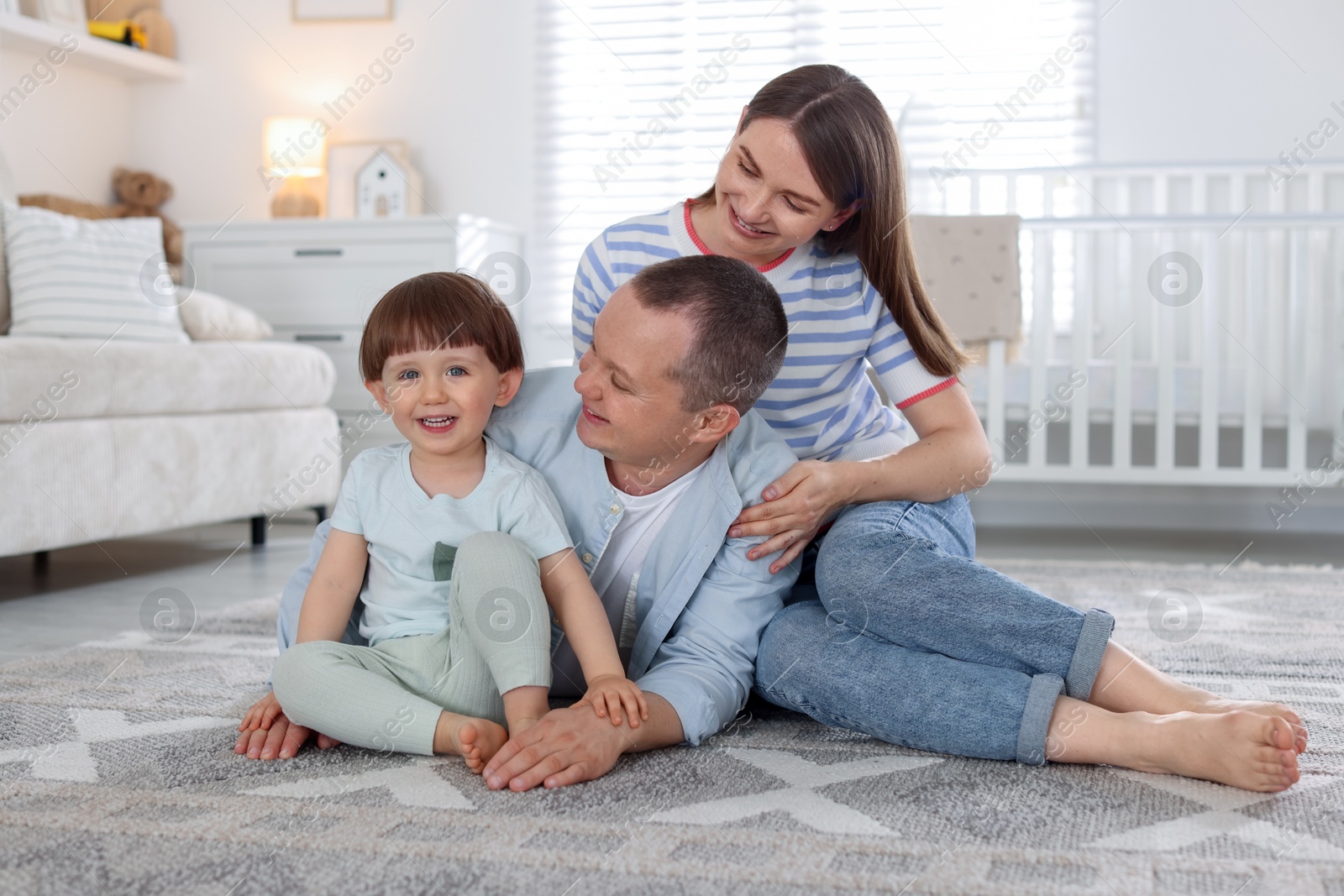 Cute little boy and his parents at home. Lovely family Photo of Cute little boy and his parents at home. Lovely family