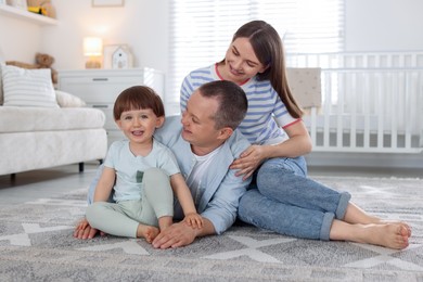 Photo of Cute little boy and his parents at home. Lovely family