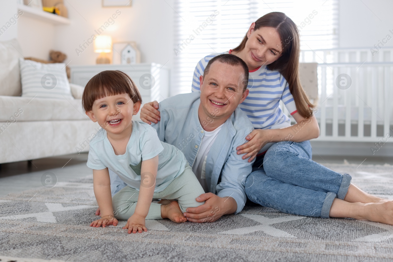 Cute little boy and his parents at home. Lovely family Photo of Cute little boy and his parents at home. Lovely family