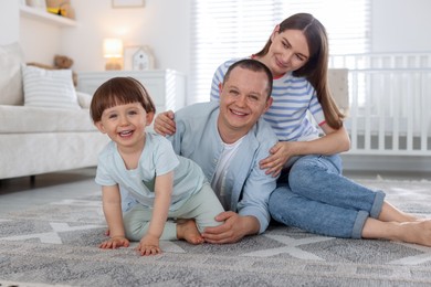 Photo of Cute little boy and his parents at home. Lovely family