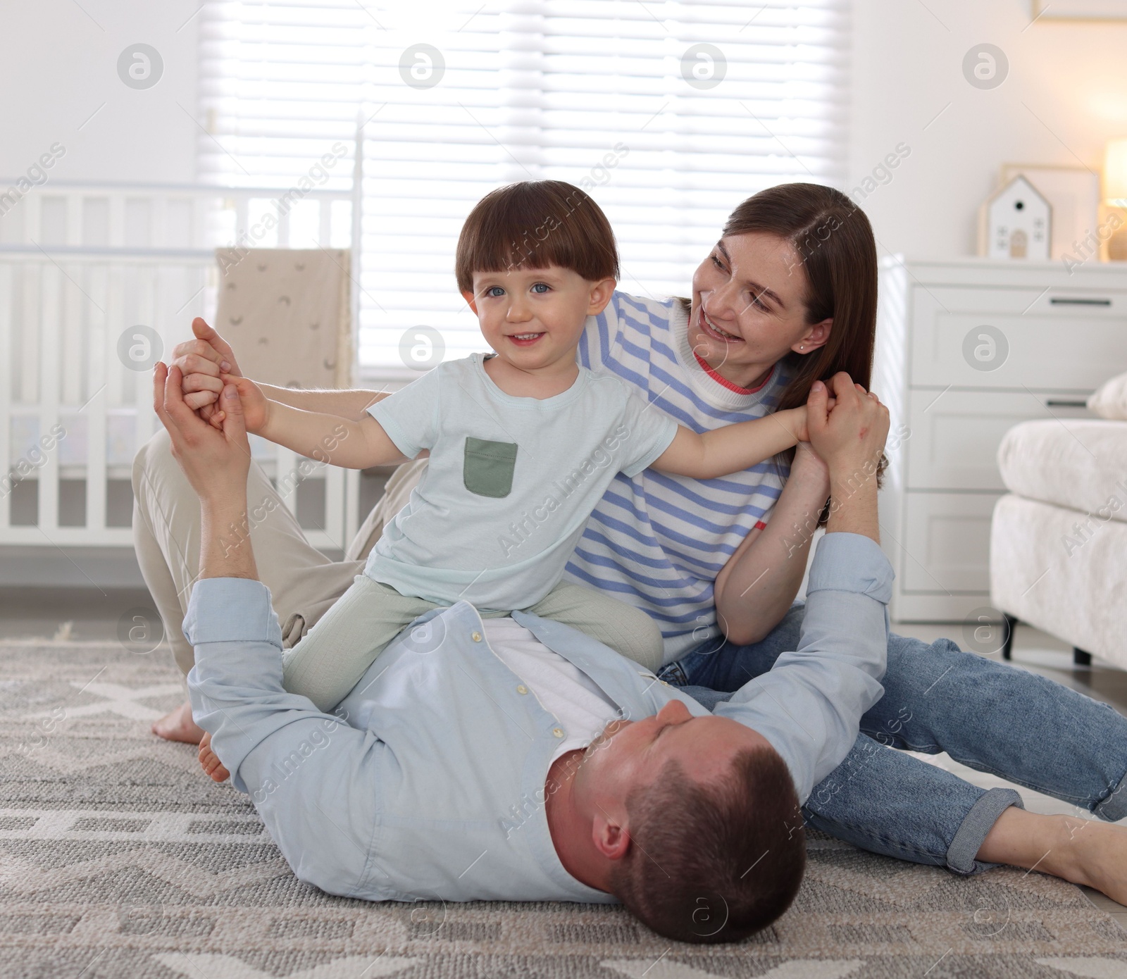 Cute little boy and his parents having fun at home. Lovely family Photo of Cute little boy and his parents having fun at home. Lovely family