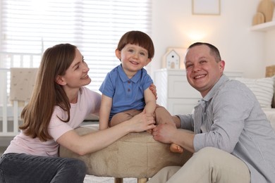 Photo of Cute little boy and his parents at home. Lovely family