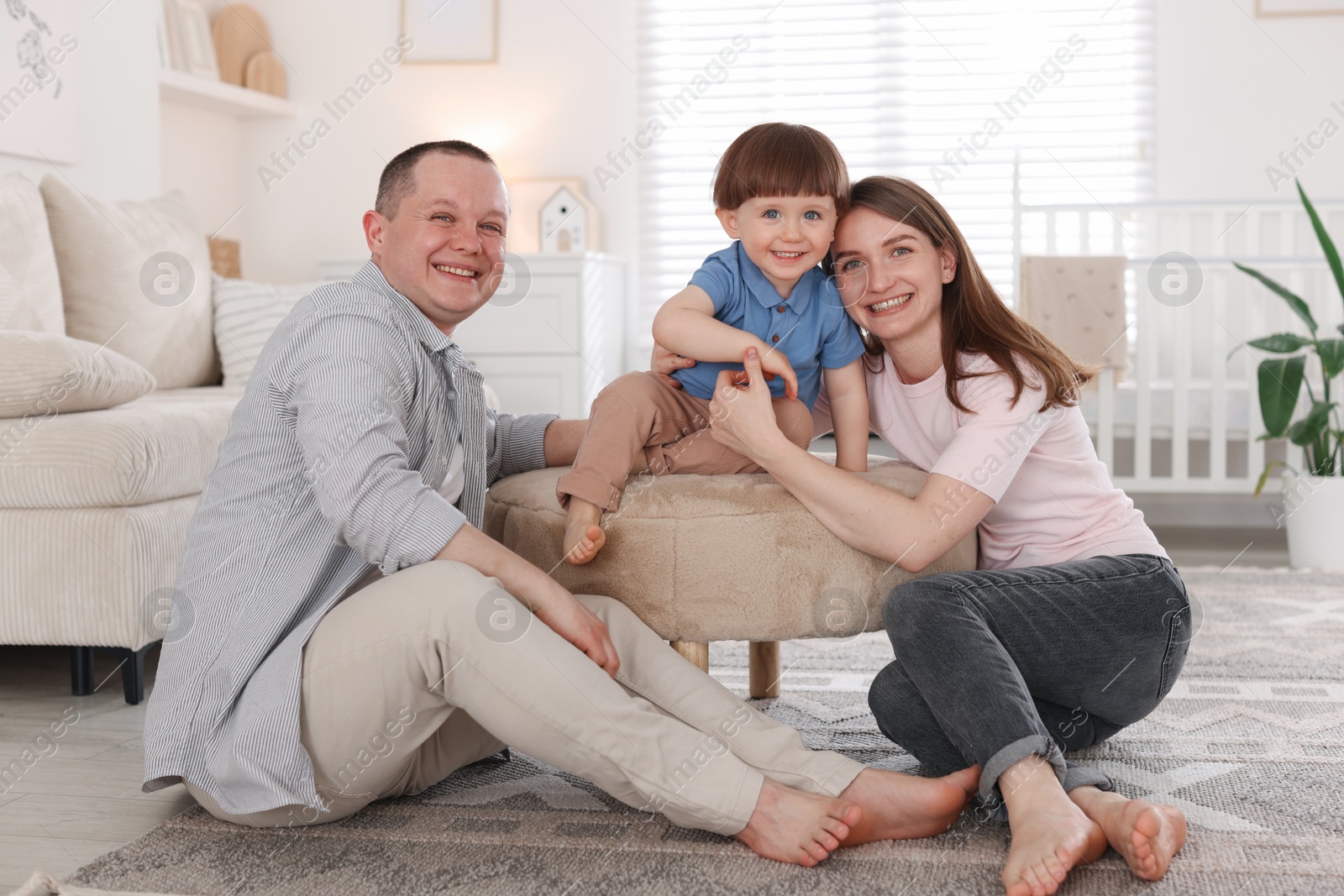 Cute little boy and his parents at home. Lovely family Photo of Cute little boy and his parents at home. Lovely family