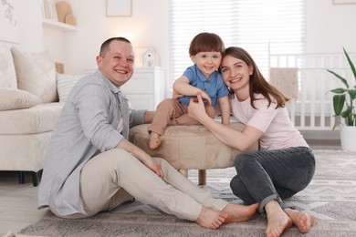 Photo of Cute little boy and his parents at home. Lovely family