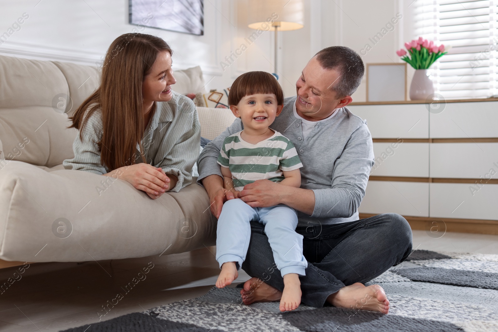 Cute little boy and his parents at home. Lovely family Photo of Cute little boy and his parents at home. Lovely family