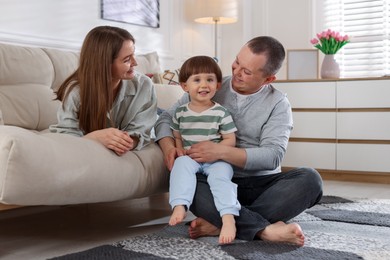 Photo of Cute little boy and his parents at home. Lovely family