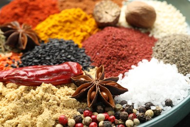 Photo of Many different aromatic spices on table, closeup