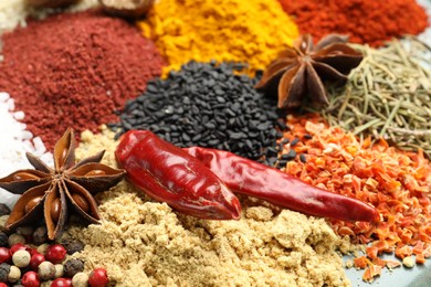Photo of Many different aromatic spices on table, closeup