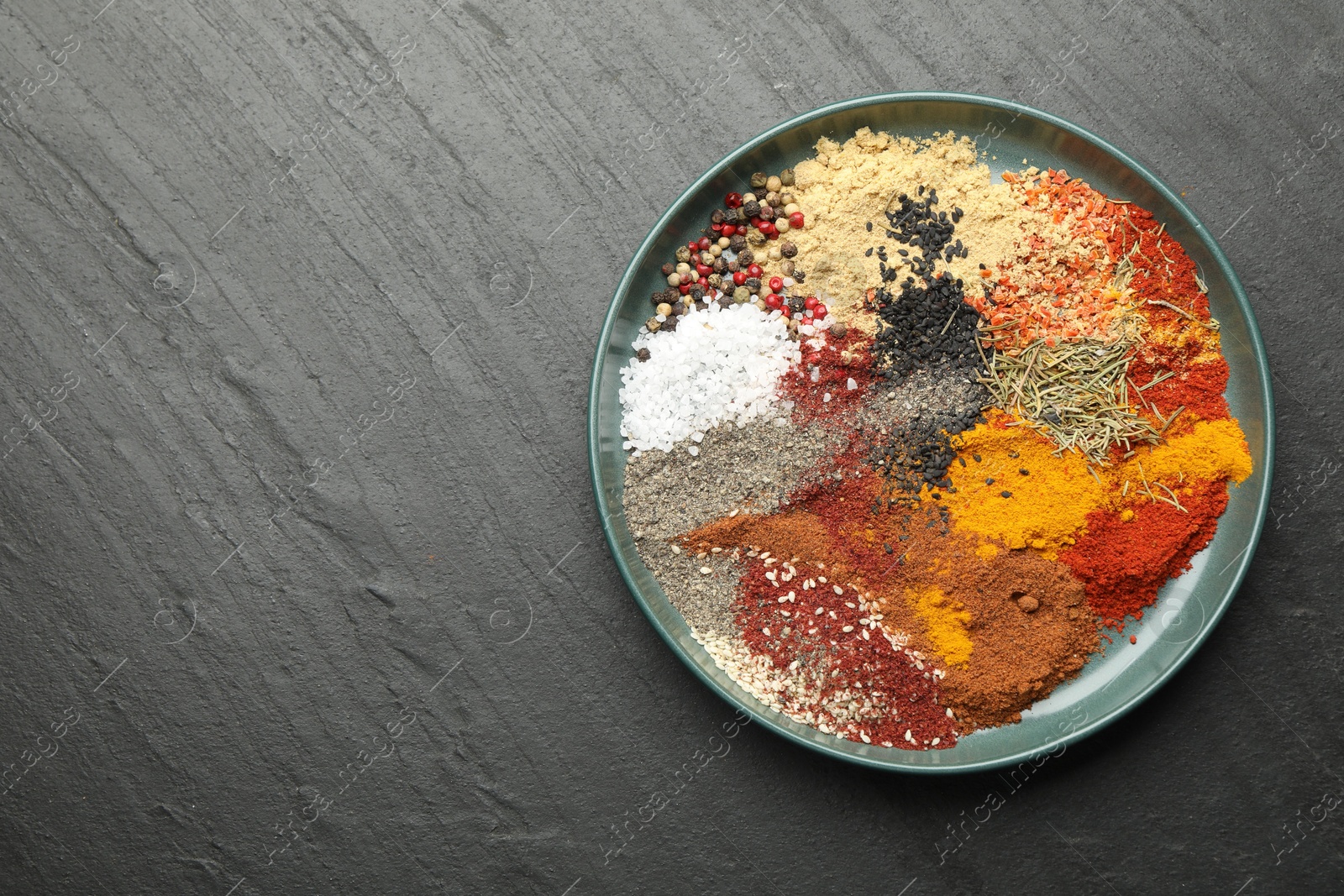 Different aromatic spices on dark textured table, top view. Space for text Photo of Different aromatic spices on dark textured table, top view. Space for text