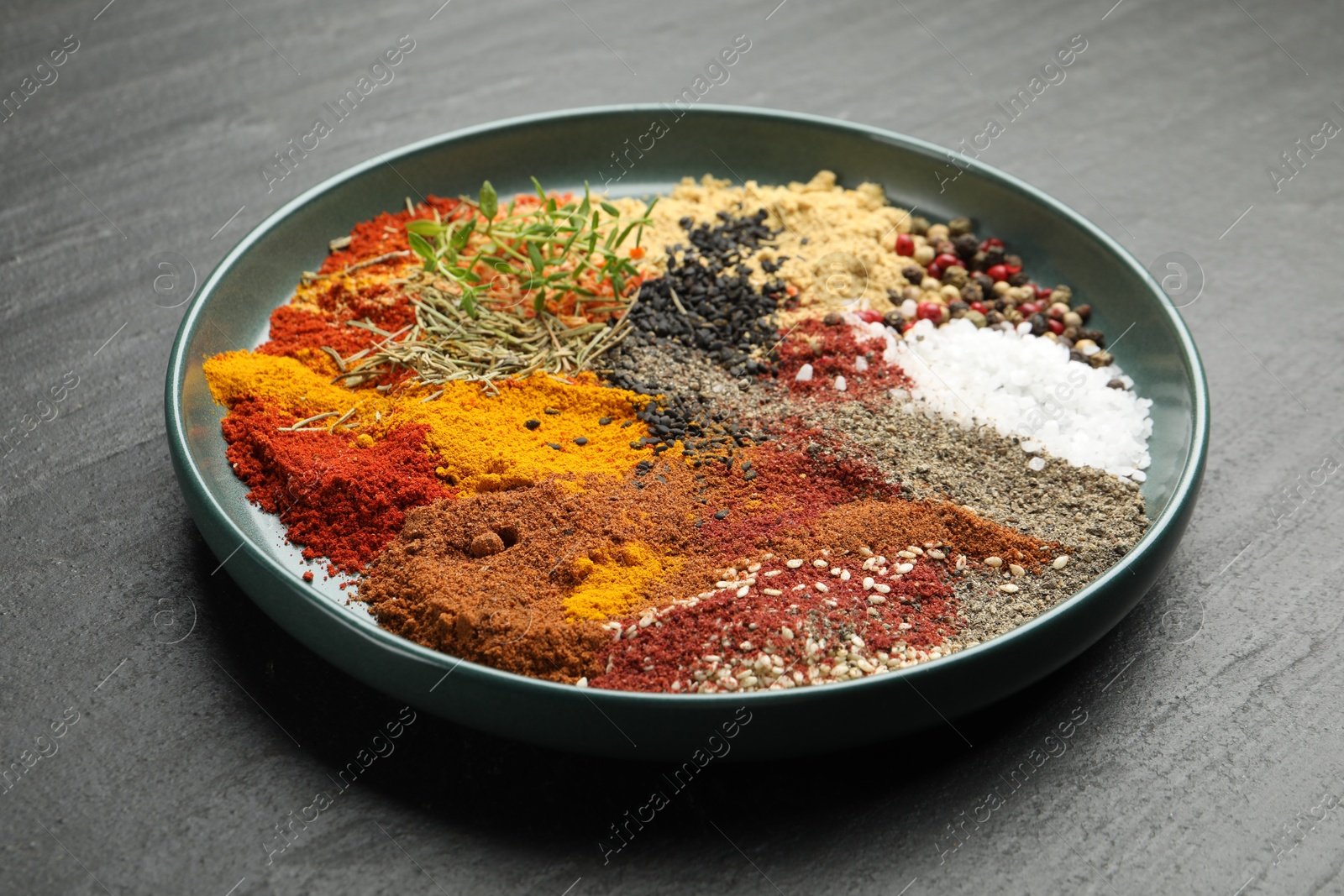 Different aromatic spices on dark textured table, closeup Photo of Different aromatic spices on dark textured table, closeup