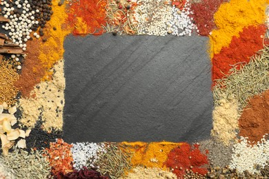 Photo of Different aromatic spices on dark textured table, top view. Space for text
