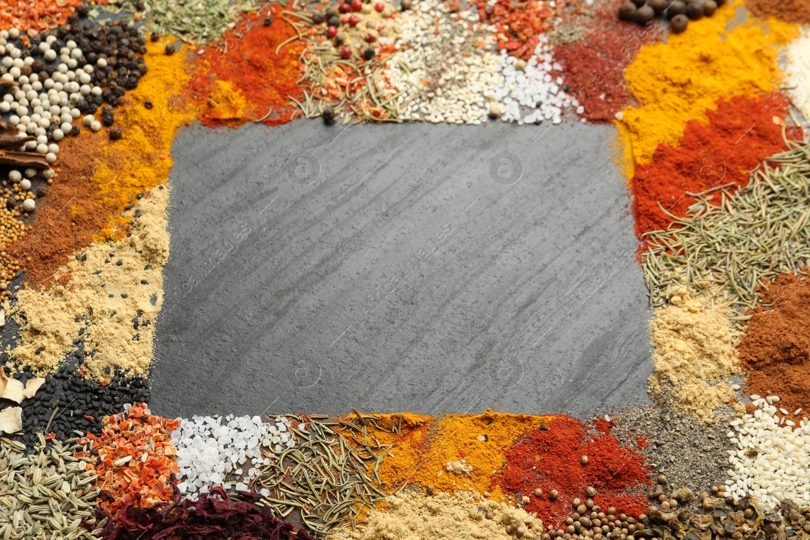 Different aromatic spices on dark textured table, top view. Space for text Photo of Different aromatic spices on dark textured table, top view. Space for text