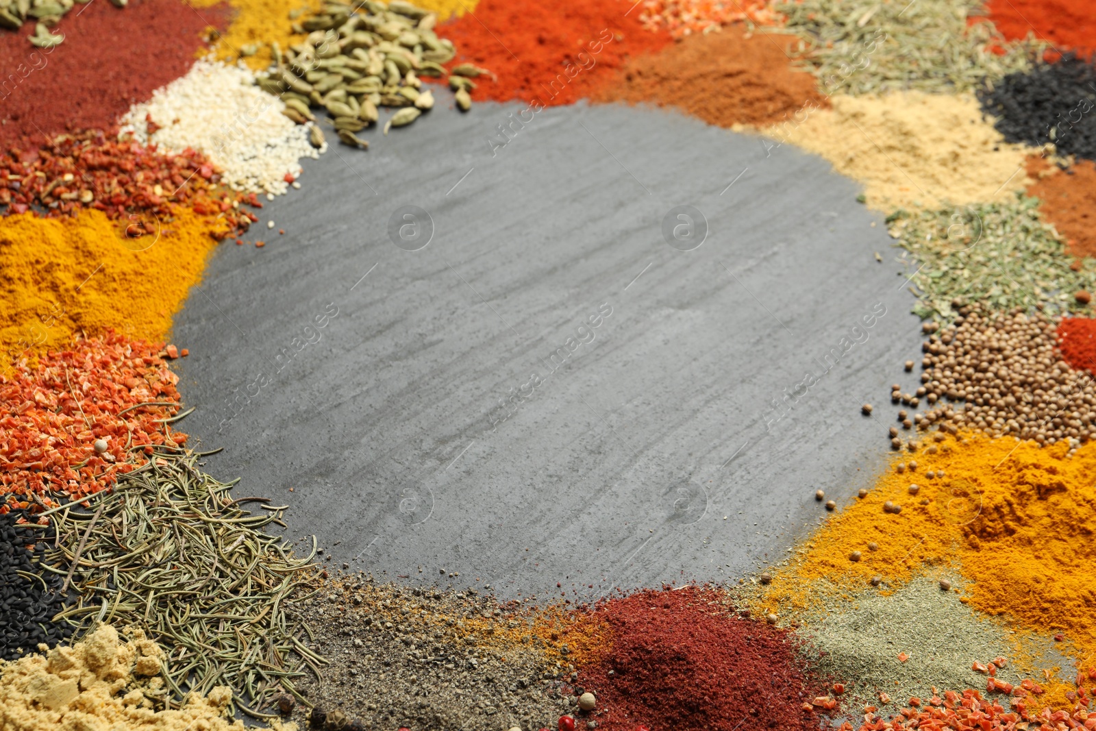 Different aromatic spices on dark textured table, closeup. Space for text Photo of Different aromatic spices on dark textured table, closeup. Space for text