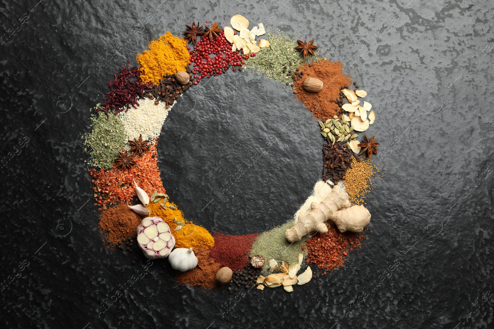 Different aromatic spices on dark textured table, top view. Space for text Photo of Different aromatic spices on dark textured table, top view. Space for text