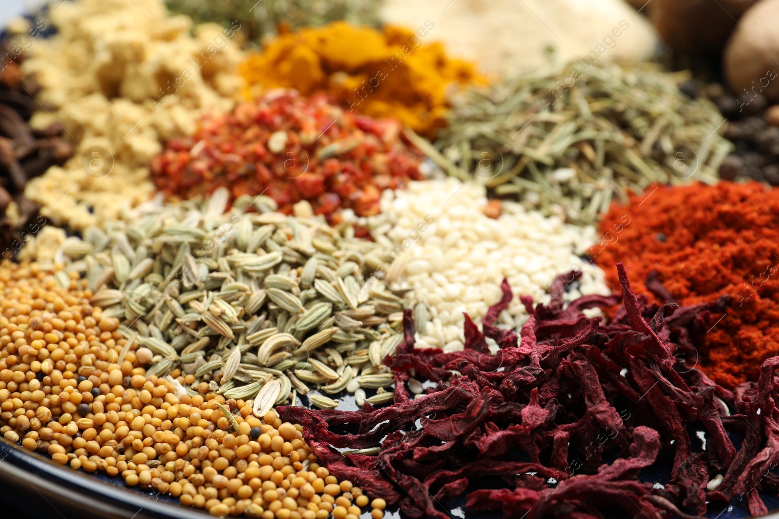 Many different aromatic spices on plate, closeup Photo of Many different aromatic spices on plate, closeup