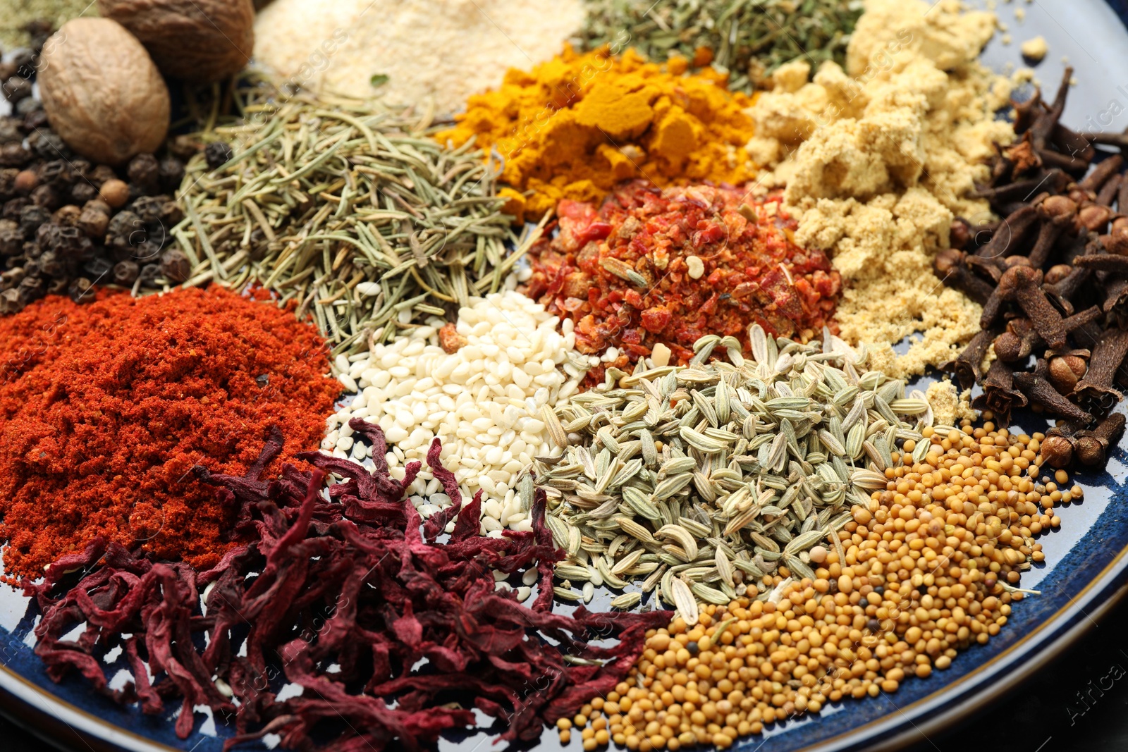 Many different aromatic spices on plate, closeup Photo of Many different aromatic spices on plate, closeup
