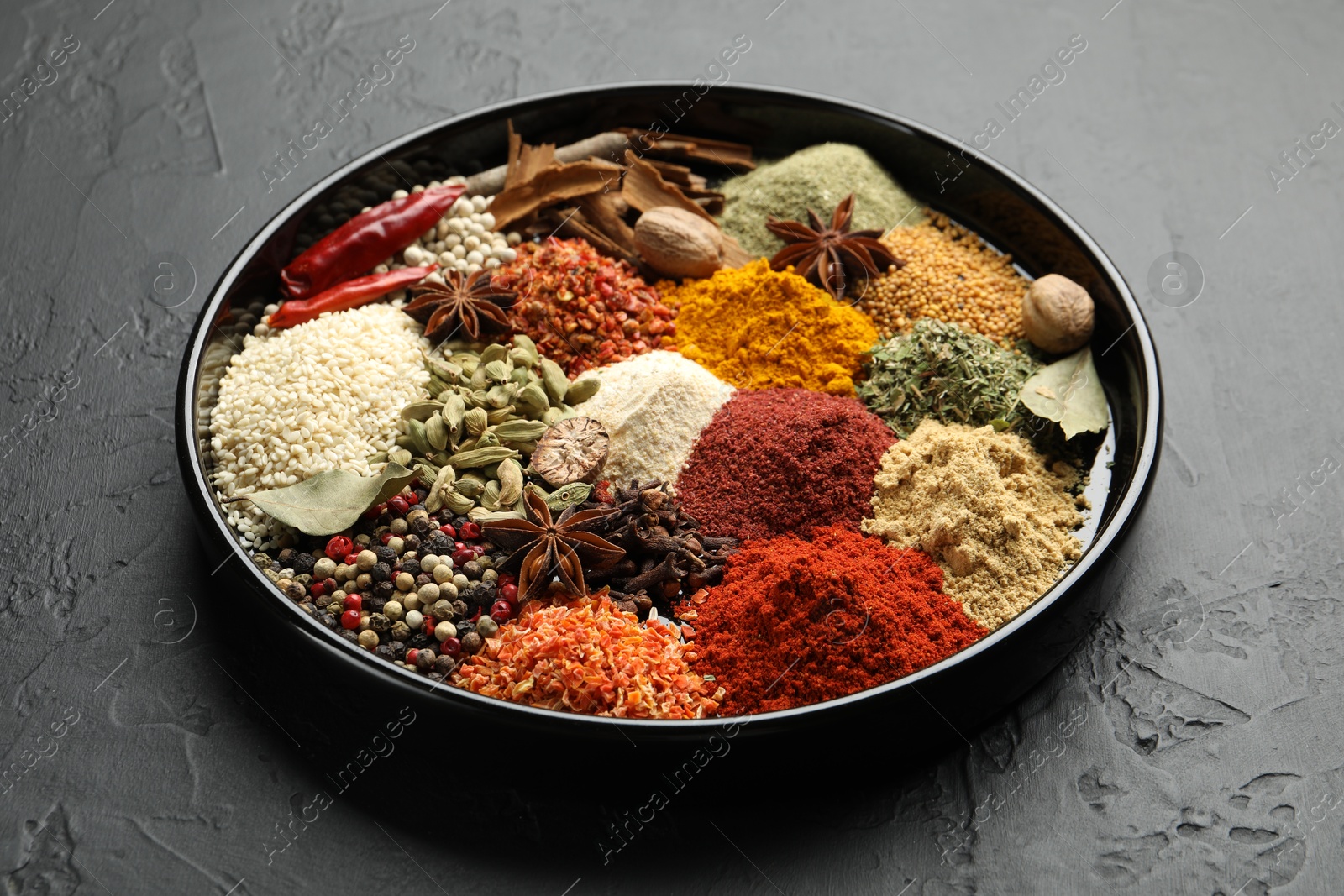 Different aromatic spices on dark textured table, closeup Photo of Different aromatic spices on dark textured table, closeup