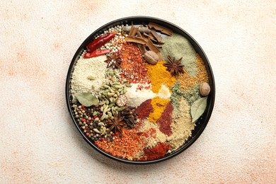 Photo of Different aromatic spices on beige textured table, top view