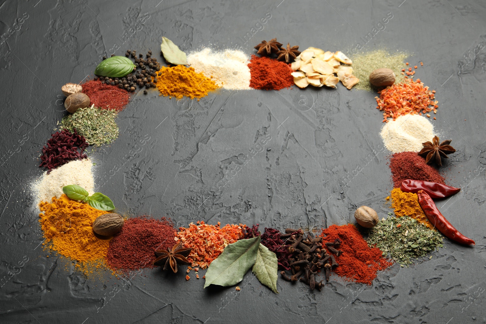 Different aromatic spices on dark textured table, space for text Photo of Different aromatic spices on dark textured table, space for text