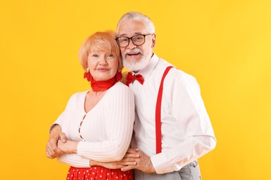 Photo of Lovely senior couple together on yellow background